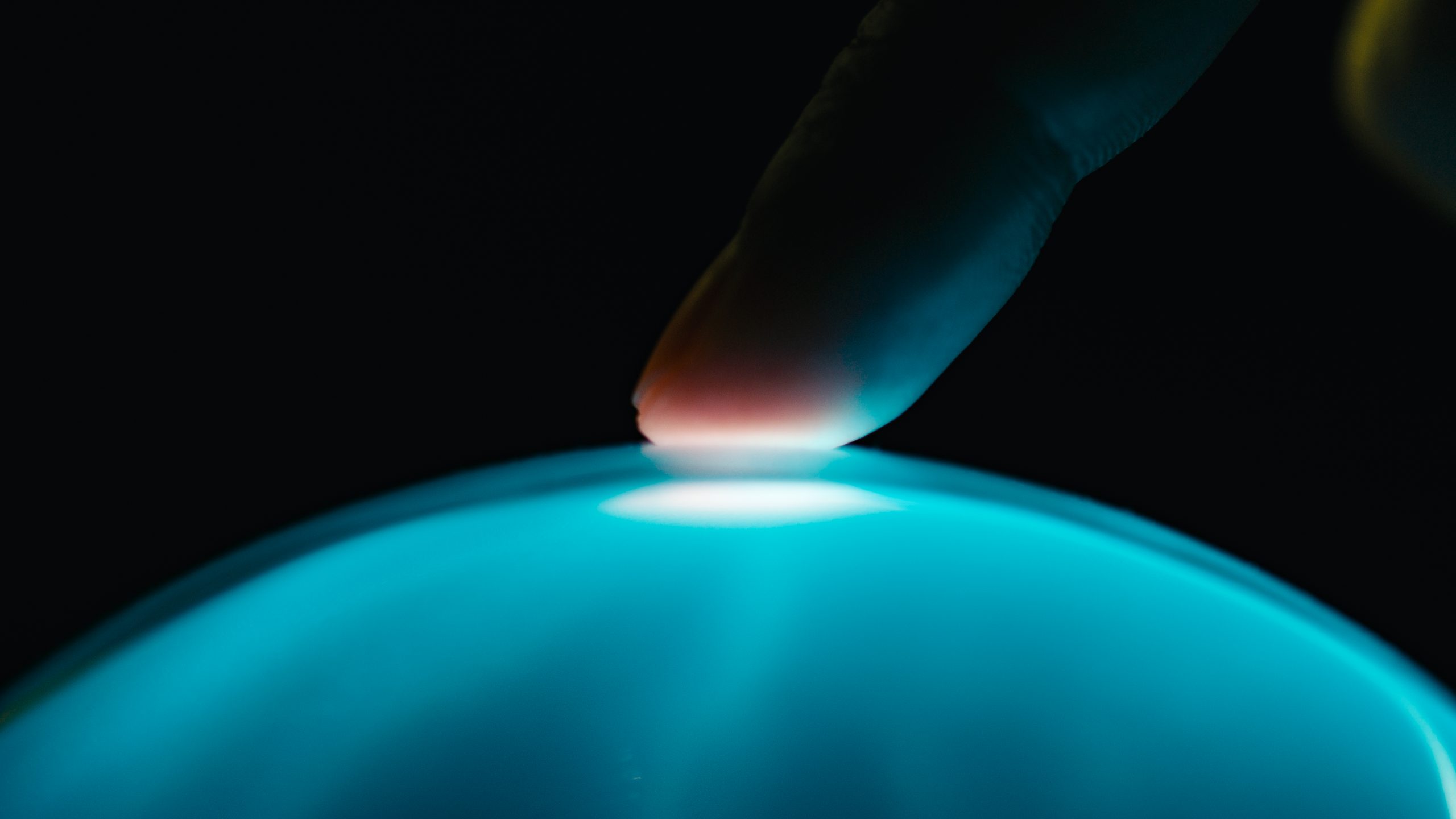 human finger interacts with artificial intelligence.